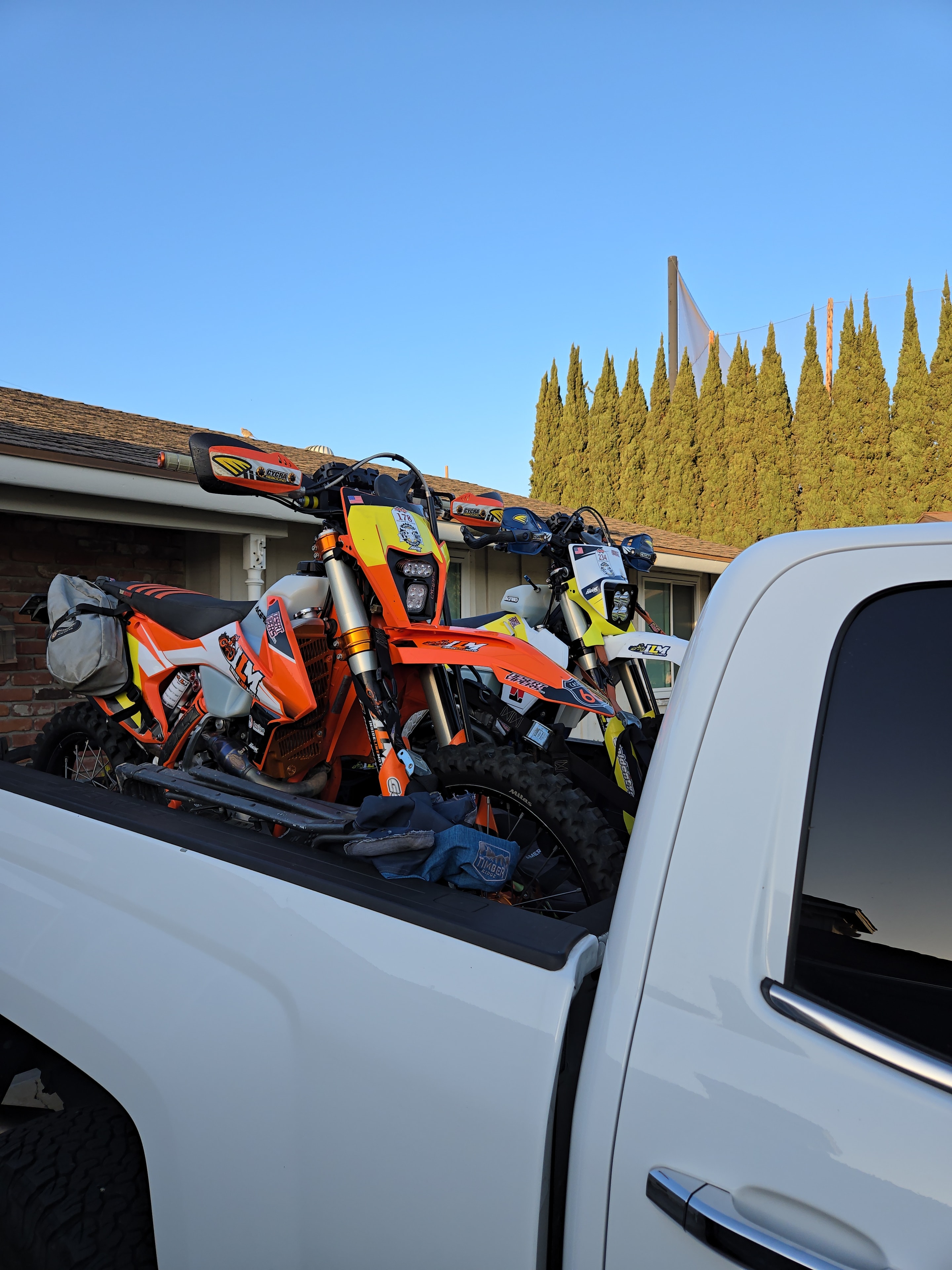 Dirt bikes loaded on pickup truck bed