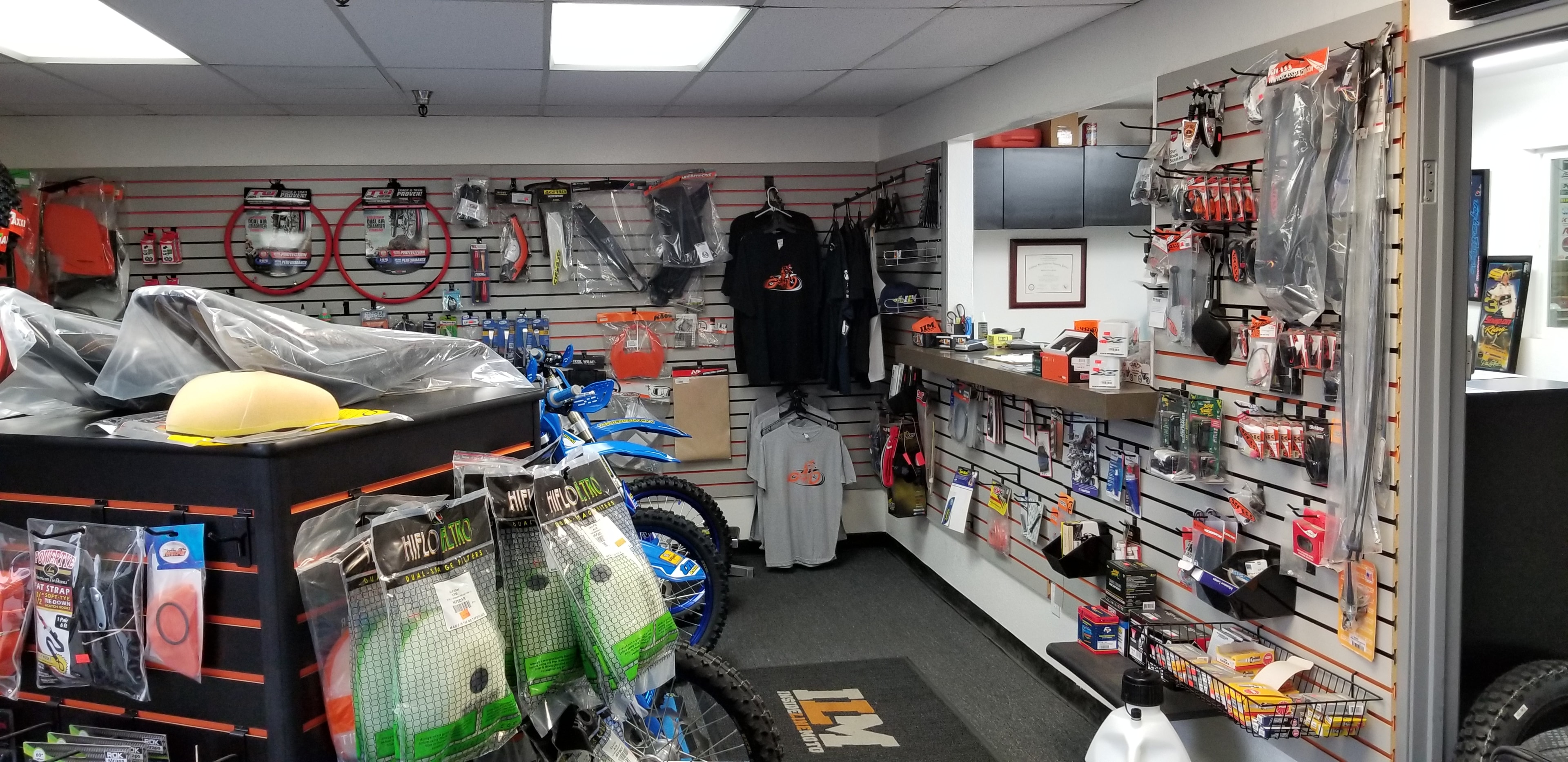 ILM shop floor with bikes, apparel, and parts wall