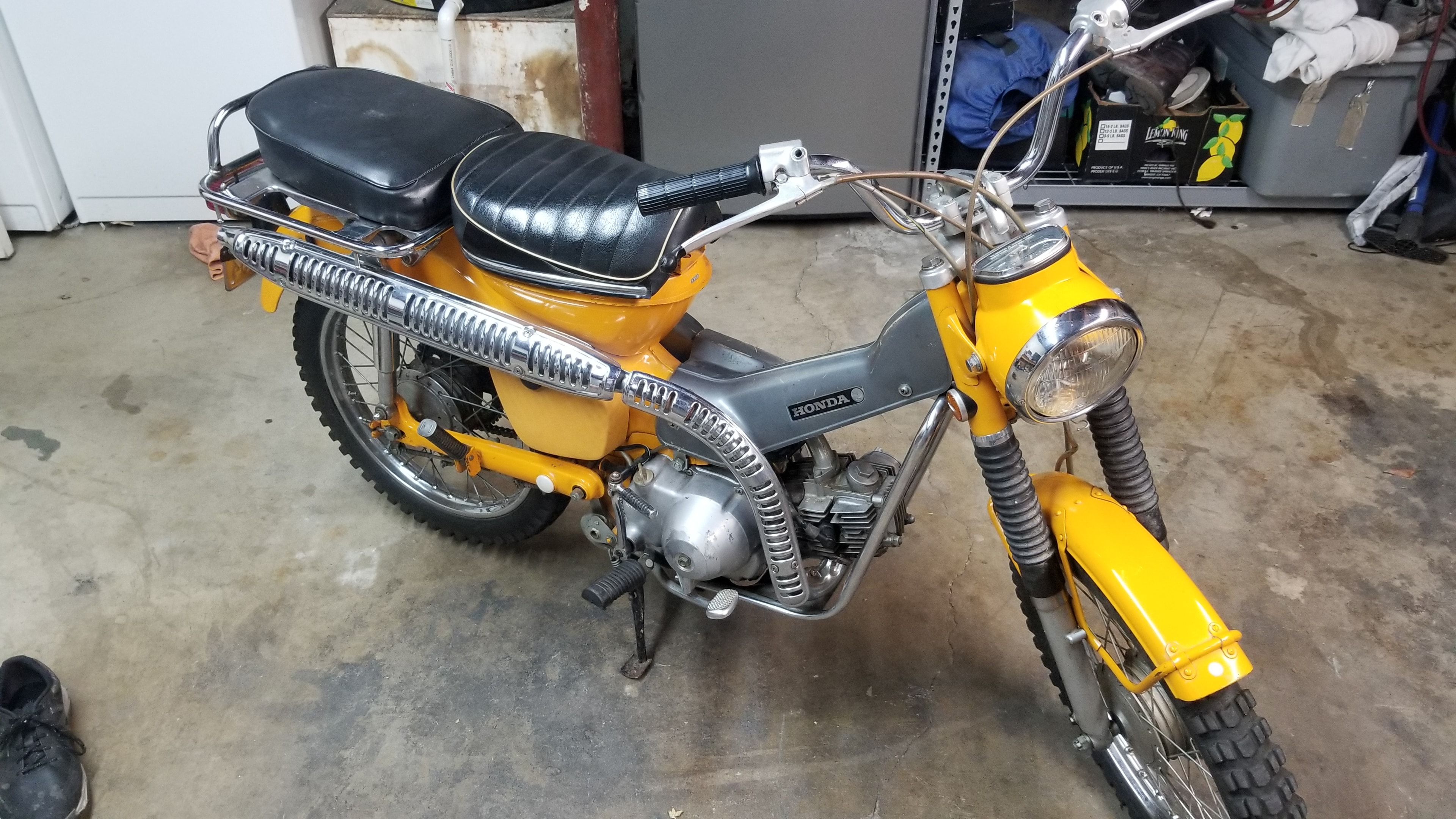 Vintage yellow Honda motorcycle in the garage
