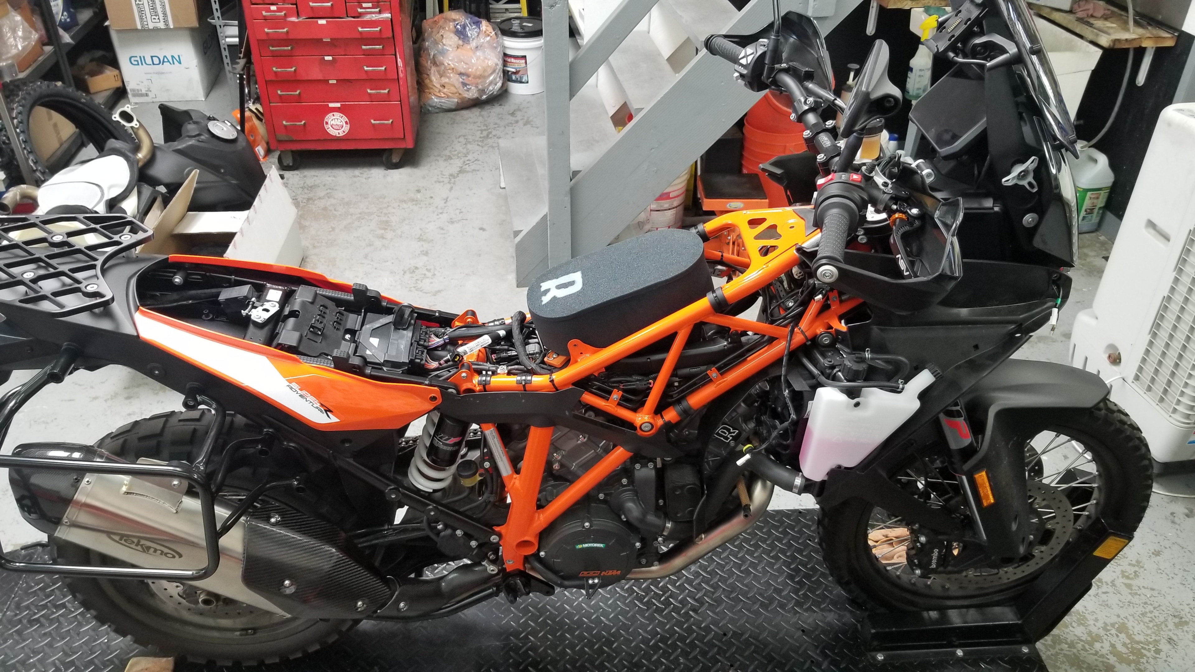 KTM Adventure bike stripped down for service in the shop