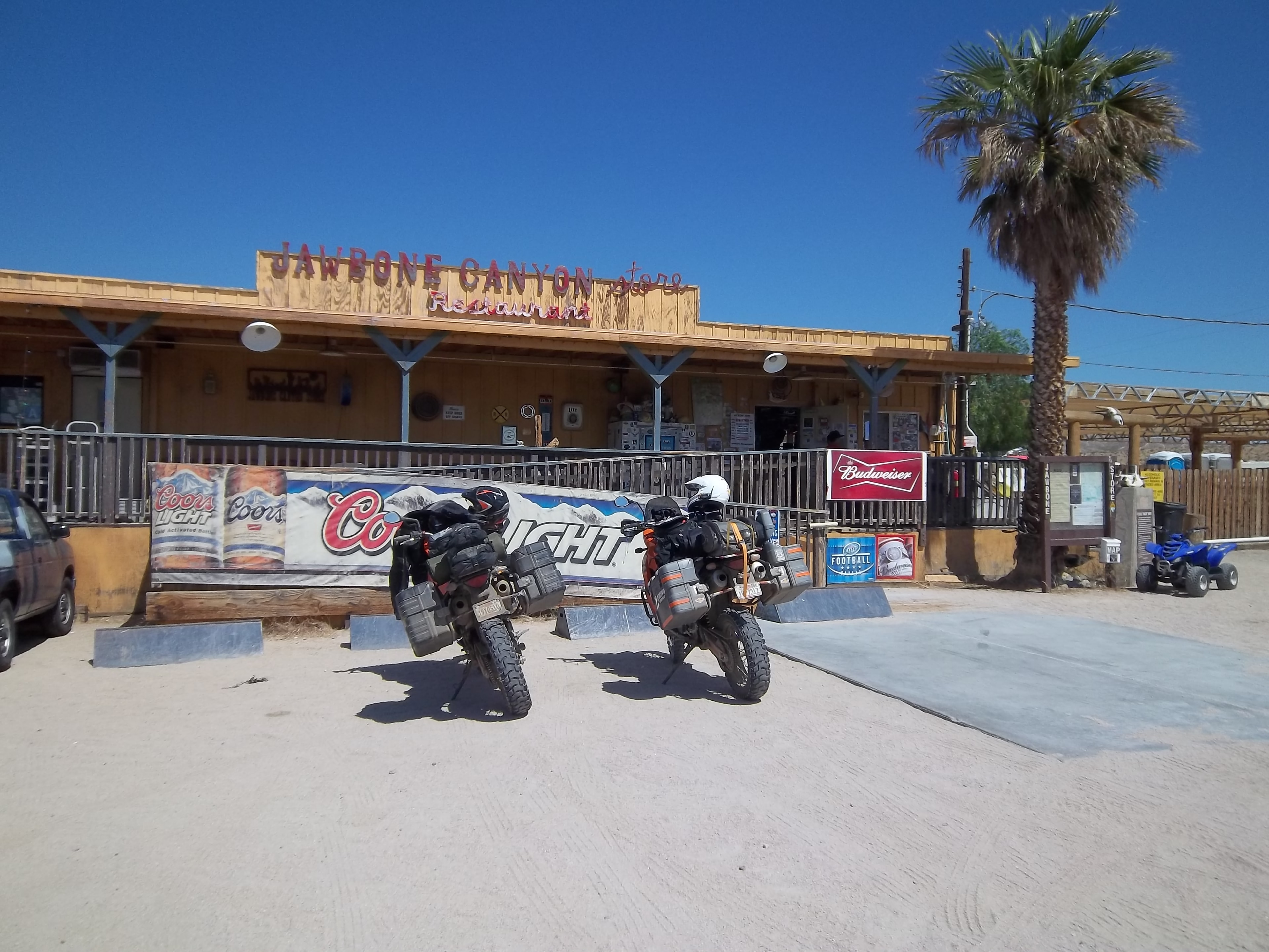 Motorcycles parked outside a desert saloon